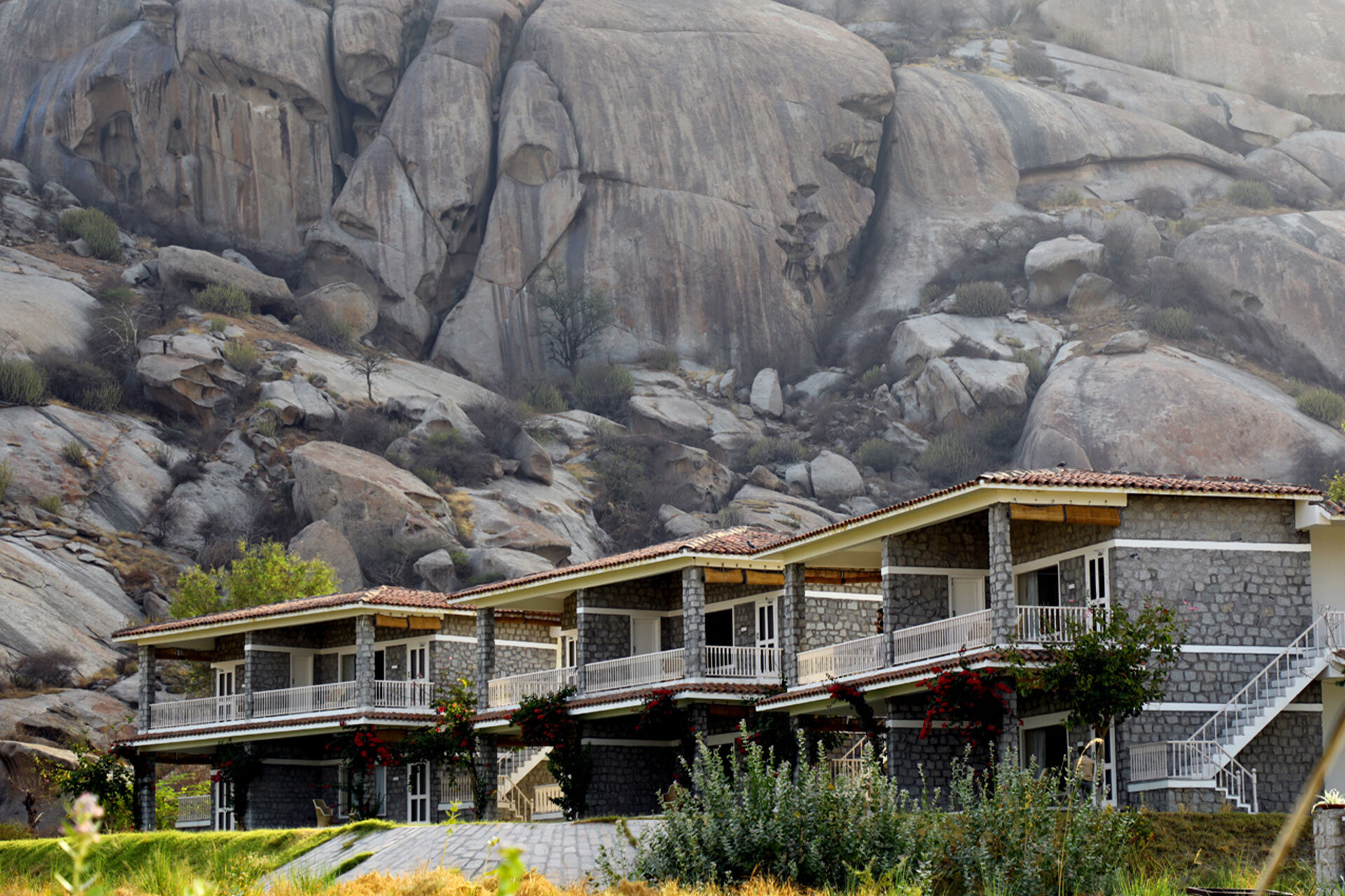 The Jawai Sagar resort rooms against granite rock formations